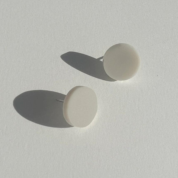 A pair of 15mm round shape Beige stud earring made from lasercut acrylic and fitted with a hypoallergenic stainless steel post.
