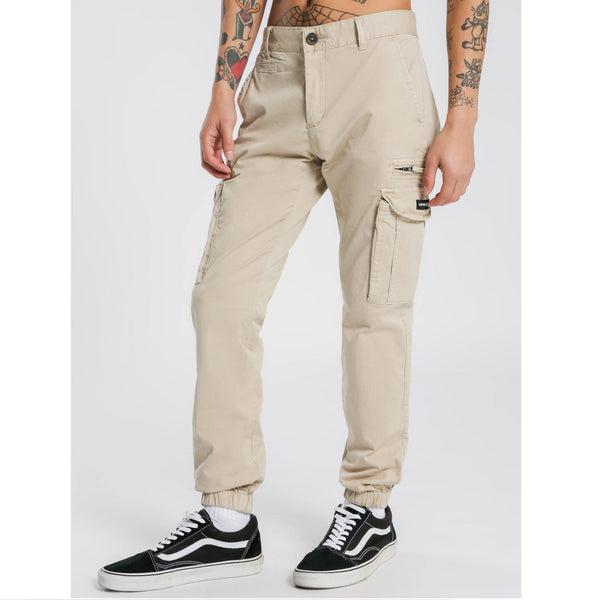 HENLEYS Eagle Pant Regular fit; tapered towards ankle. Pure cotton twill; non-stretch. Zip fly and button fastening. Eight-pocket design; button fastenings to reverse welt pockets; cargo-style pockets to each thigh; zip pocket to left thigh. Belt loops. Ribbed cuffs. Available at My Harley and Rose.