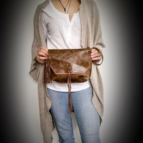Distressed Tassel Satchel, Made from our favourite cowhide distressed leather in brown, this clutch is a real statement piece. Exposed seams, detachable wristlet strap and tassel with antique bronze hardware. Don’t miss out, this is a limited edition clutch.. it won’t last! Available at My Harley and Rose