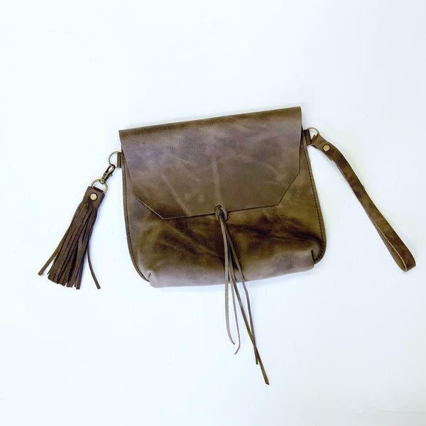 Distressed Tassel Satchel, Made from our favourite cowhide distressed leather in brown, this clutch is a real statement piece. Exposed seams, detachable wristlet strap and tassel with antique bronze hardware. Don’t miss out, this is a limited edition clutch.. it won’t last! Available at My Harley and Rose